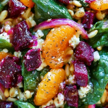 Beet salad with spinach, mandarin oranges, red onion, pine nuts, and feta cheese