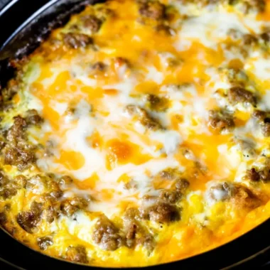 Cheesy sausage hashbrown breakfast dish with golden hashbrowns and sausage