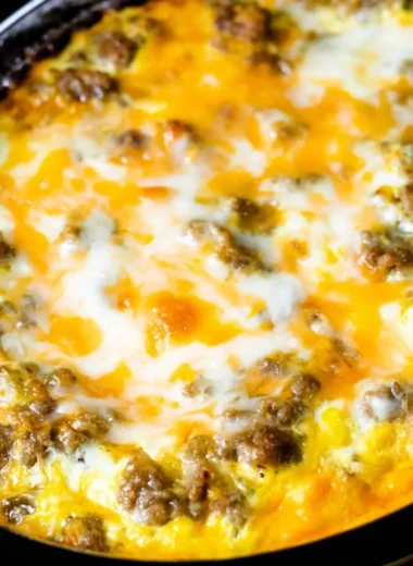 Cheesy sausage hashbrown breakfast dish with golden hashbrowns and sausage