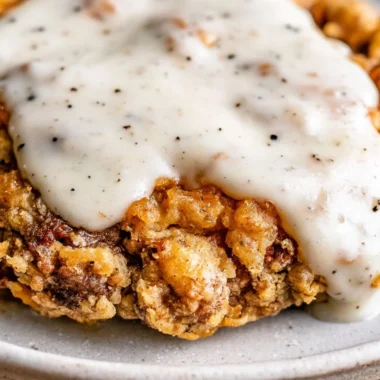 Delicious chicken fried steak served with creamy gravy and side dishes.