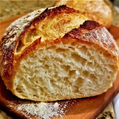 Delicious loaf of no knead gluten free bread on a rustic wooden table.