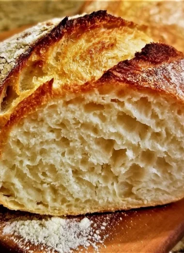 Delicious loaf of no knead gluten free bread on a rustic wooden table.