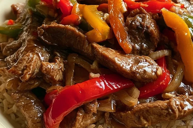Cozy slow cooker pepper steak served with rice and bell peppers