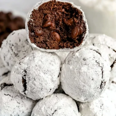 Double chocolate snowball cookies dusted with powdered sugar, a delicious treat.