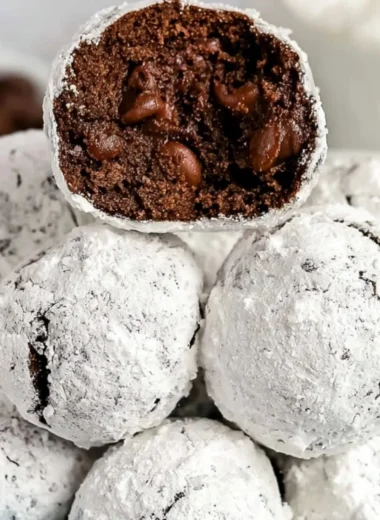 Double chocolate snowball cookies dusted with powdered sugar, a delicious treat.