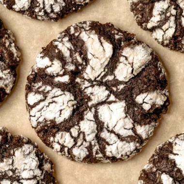 Delicious batch of homemade chocolate crinkle cookies with powdered sugar coating