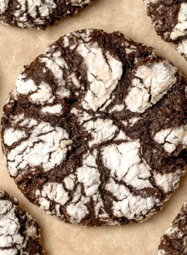 Delicious batch of homemade chocolate crinkle cookies with powdered sugar coating