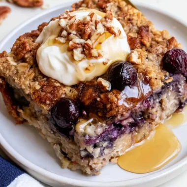 Delicious blueberry baked oatmeal served in a bowl, topped with fresh blueberries.