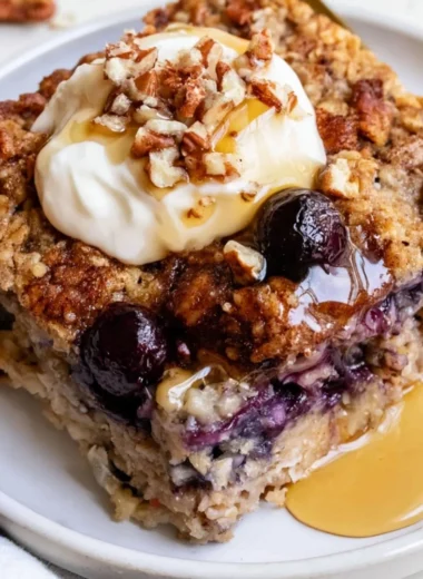 Delicious blueberry baked oatmeal served in a bowl, topped with fresh blueberries.
