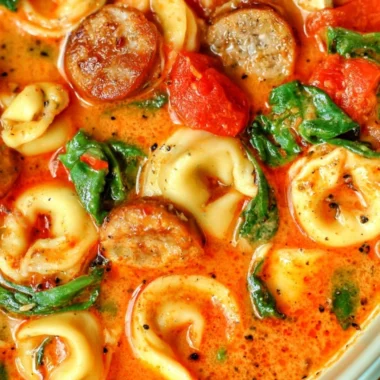Bowl of healthy tortellini soup with vegetables and herbs