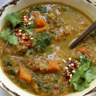 Bowl of sweet potato lentil stew filled with vegetables and spices.